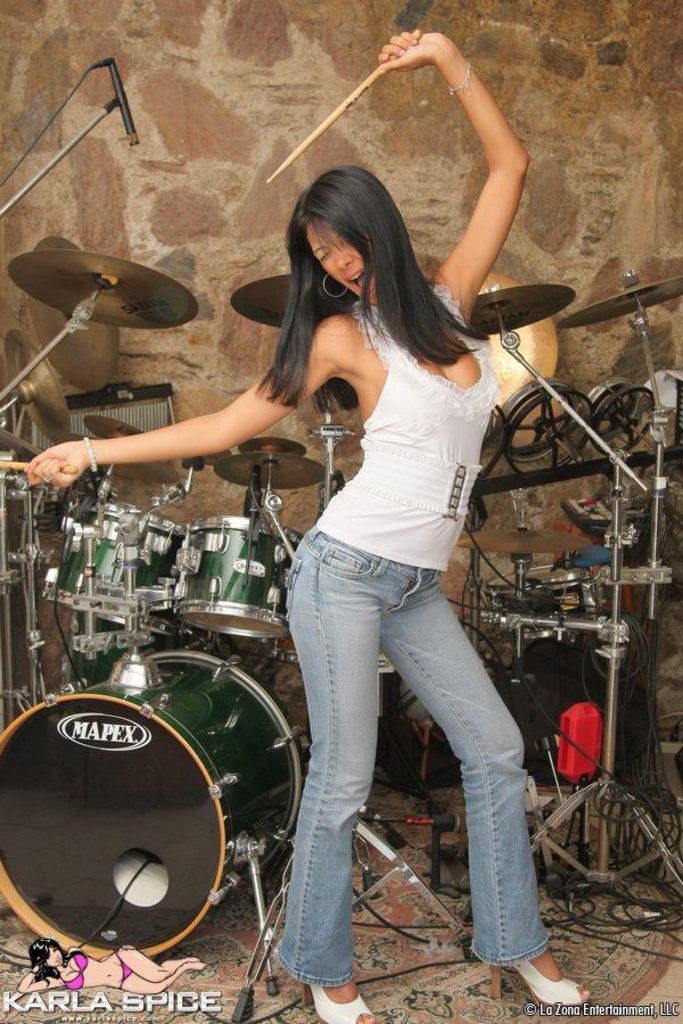 Karla Strips from Streetwear to Green Bikini beside a Drum Kit photo 2
