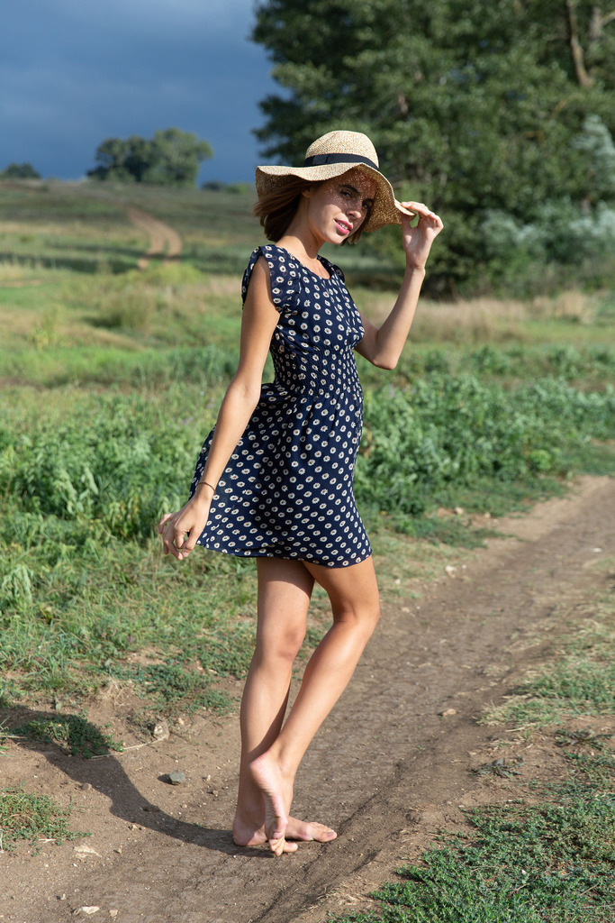 Polka-Dot Dress and Nude Posing beneath Open Country Skies photo 2