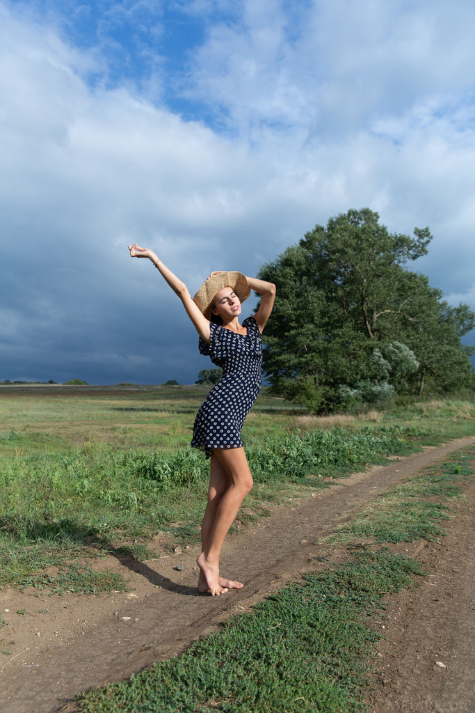 Polka-Dot Dress and Nude Posing beneath Open Country Skies photo 3