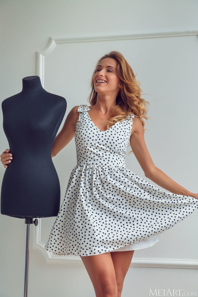 Cara Mell Poses beside a Polka-Dot Dress and Mannequin photo 6