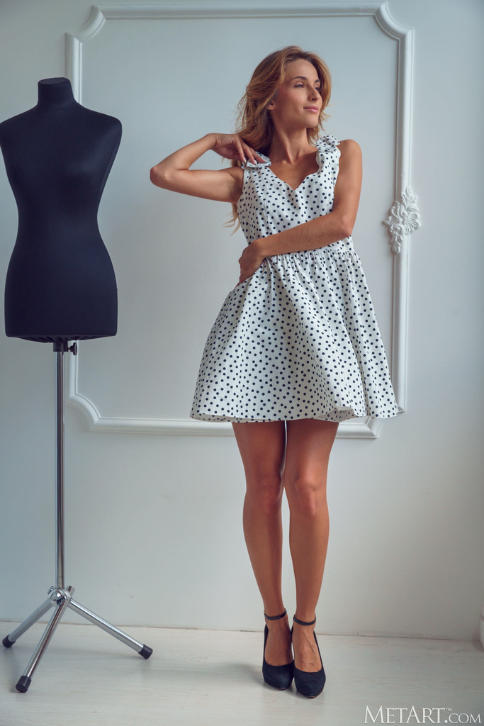 Cara Mell Poses beside a Polka-Dot Dress and Mannequin photo 11