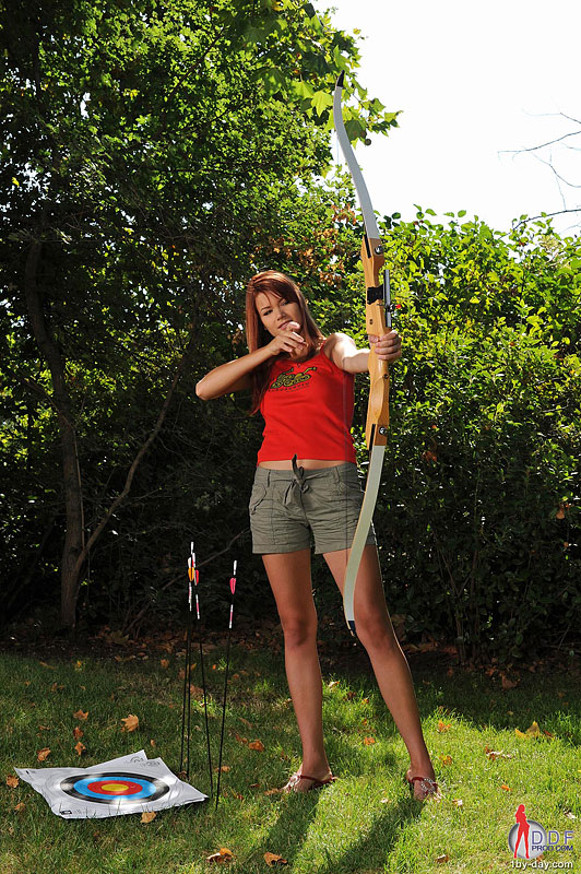 Kami Strips Outdoors Beside an Archery Target photo 2