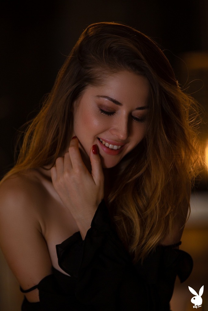 Black Bodysuit Poses in a Low-Lit Bar Interior photo 4