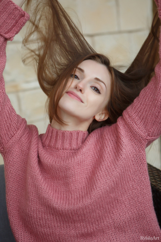Asziu in a Pink Sweater by the Red Sofa photo 3