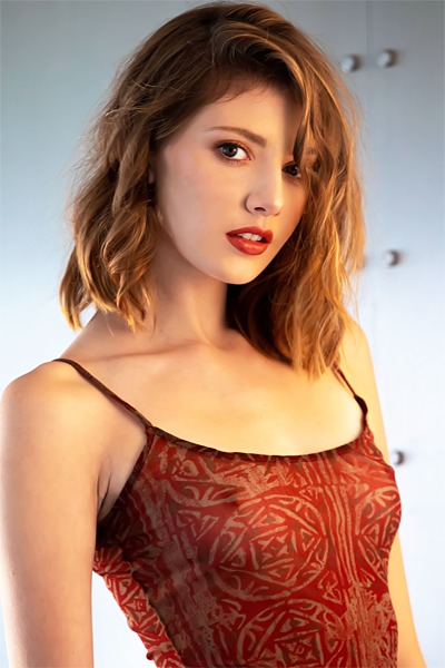 Lena in a Copper Top and Black Bottoms on a Dark Studio Set