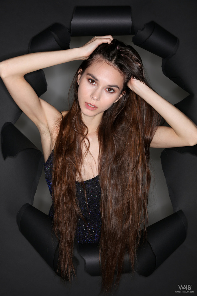 Black Cutout Dress on a Sculptural Chair in a Dark Studio photo 1